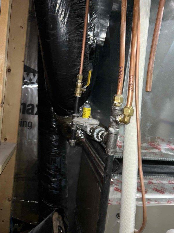 Responded to report of gas odor in basement near furnace. Upon arrival, conducted thorough investigation and identified gas leak at burner orifices. Inspection revealed that while orifices were properly seated, the gas valve was failing to close completely, allowing gas to pass through the manifold and escape from all three burner orifices. Utilized gas detection equipment to confirm active leakage and performed comprehensive safety check of all surrounding fittings, joints, and valve body connections to rule out additional external leak points. No other leaks were detected at this time. Due to safety hazard, immediately shut off gas supply to the unit, placing heating system out of service until necessary repairs can be completed. Documented findings with photographs showing equipment location and valve assembly. Parts request submitted to determine warranty eligibility and obtain replacement gas valve specifications.