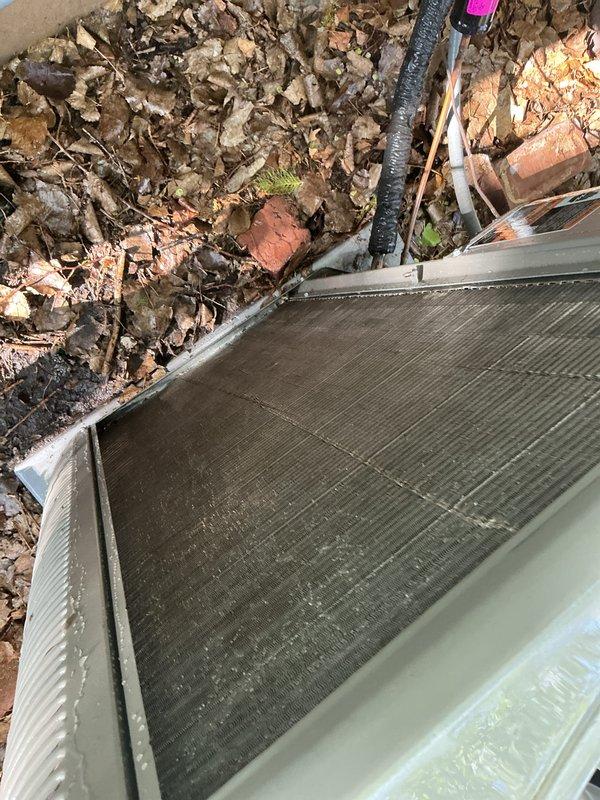 Completed annual Family Rewards cooling maintenance visit on a one-year-old system. Found condenser coil with buildup and dirty filter; thoroughly cleaned condenser coil and replaced air filter. System operating properly with no additional issues identified.