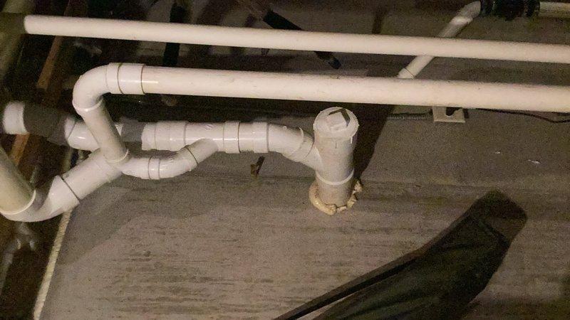 Completed comprehensive plumbing inspection of residential property. Inspected PVC drainage system beneath floor structure, including trap configurations, horizontal drain lines, and brass floor drain connection point. All plumbing components, fixtures, and accessible piping were visually examined and found to be in proper working order with no leaks or deficiencies noted at time of inspection.