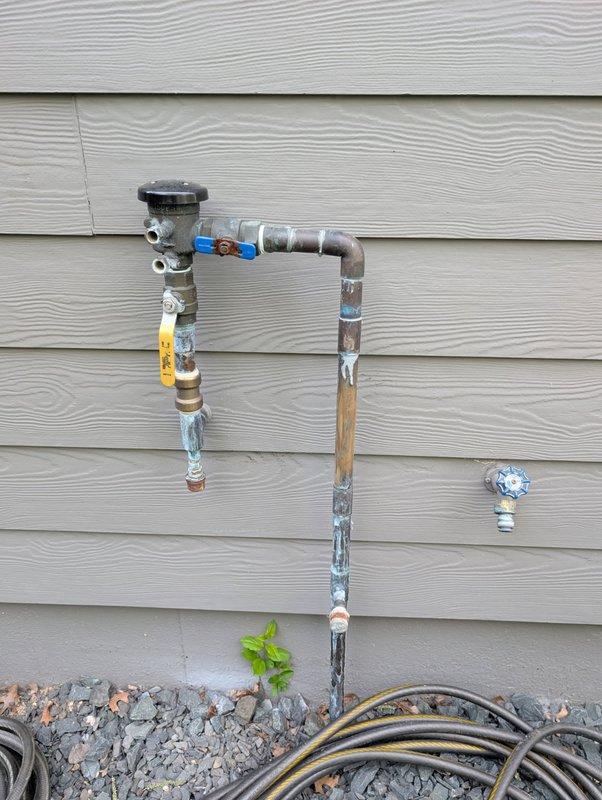 Responded to exterior irrigation system water leak caused by winter freeze damage. Upon inspection, identified failed shut-off valve that was bypassing and not completely sealing, which allowed water to leak through the system during winter months, resulting in a burst copper riser pipe. Replaced defective ball valve with new unit to ensure proper shut-off capability. Repaired damaged copper riser pipe section on exterior of building. Tested system for proper operation and verified complete seal at shut-off valve with no further leakage detected.