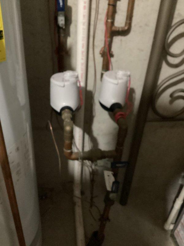 Completed comprehensive plumbing inspection of residential water heating system, including evaluation of dual water heater installation, copper supply and distribution piping, pressure relief valves, and associated connections. Documented existing equipment conditions with photographic evidence showing proper mounting, piping configuration, and functional components in basement mechanical room.