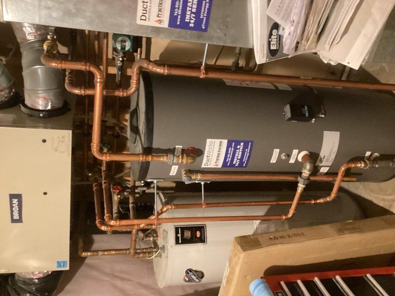 Responded to service call for boiler leak and system concerns. Upon inspection, identified multiple components requiring replacement and confirmed leak at boiler unit. Evaluated infloor heating tank which was not heating properly and discussed system update options with homeowner. Installed new smart thermostat for heating and cooling zone, successfully programmed unit and connected to mobile application. Assessed recirculation system and documented need for additional recirculating pump on domestic hot water side. Photographed existing equipment configuration including boiler, expansion tank, copper piping connections, and recirculation components for future reference and system upgrade planning.