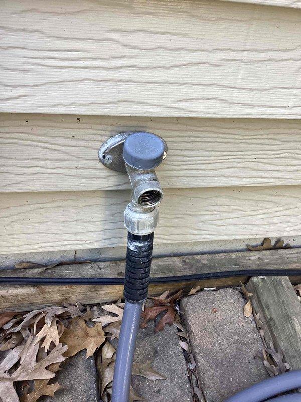 Responded to exterior water spigot leak on north side of residence. Upon inspection, identified faulty stem assembly causing visible leak at hose bib fixture mounted to wood-sided exterior wall. Customer confirmed leak location and noted water shutoff was not required. Diagnosed worn stem component requiring replacement. Ordered necessary replacement parts for stem assembly to complete repair and restore proper function to outdoor faucet. Documented existing conditions with photographs showing spigot installation, connection points, and measurement reference.