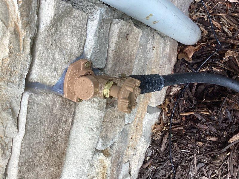 Responded to a leaking outdoor hose bib that would not shut off completely. Removed the failed hose bib assembly and installed a new brass hose bib with backflow preventer along with a new shutoff valve. Verified proper operation and confirmed no leaks at connections. The exterior water supply connection is now functioning correctly with full shutoff capability.