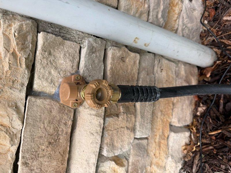 Responded to a leaking outdoor hose bib that would not shut off completely. Removed the failed hose bib assembly and installed a new brass hose bib with backflow preventer along with a new shutoff valve. Verified proper operation and confirmed no leaks at connections. The exterior water supply connection is now functioning correctly with full shutoff capability.