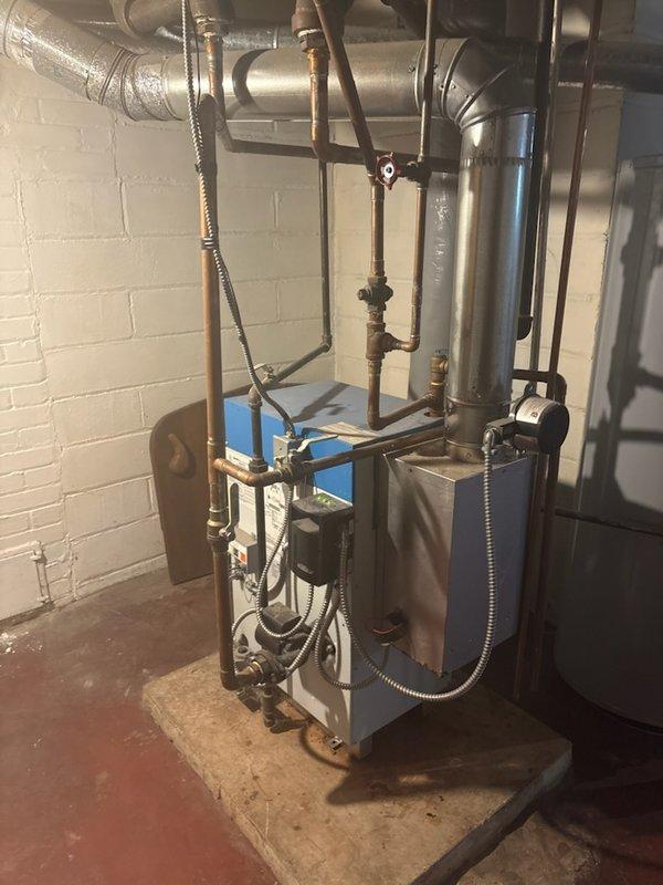 Performed comprehensive city inspection with certification on Slant Fin boiler system for residential property sale contingency. Conducted thorough operational assessment including burner condition, circulator pump function, all safety controls, damper operation, backflow preventer, piping integrity, seal integrity for carbon monoxide leakage, combustion analysis, and pressure relief valve operation. All components tested within acceptable parameters with no active leaks detected in piping or seals. Heat exchanger inspection revealed no visible cracks; however, noted evidence of minor water seepage indicated by yellow corrosion deposits on heat exchanger surfaces and rust staining on refractory components. Reviewed findings and repair options with homeowner. Issued passing certification confirming boiler is safe for continued operation.