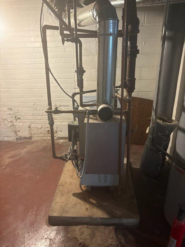 Performed comprehensive city inspection with certification on Slant Fin boiler system for residential property sale contingency. Conducted thorough operational assessment including burner condition, circulator pump function, all safety controls, damper operation, backflow preventer, piping integrity, seal integrity for carbon monoxide leakage, combustion analysis, and pressure relief valve operation. All components tested within acceptable parameters with no active leaks detected in piping or seals. Heat exchanger inspection revealed no visible cracks; however, noted evidence of minor water seepage indicated by yellow corrosion deposits on heat exchanger surfaces and rust staining on refractory components. Reviewed findings and repair options with homeowner. Issued passing certification confirming boiler is safe for continued operation.