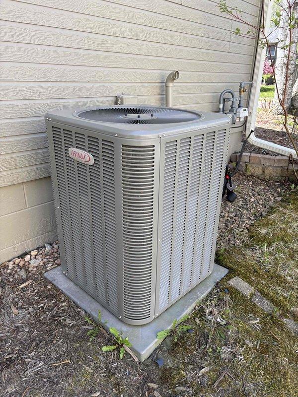 Completed annual air conditioning tune-up and maintenance on one Lennox outdoor condensing unit. Performed comprehensive system inspection including filter check, thermostat operation verification, temperature differential measurement, condenser coil inspection, motor operation assessment, capacitor testing with digital multimeter, compressor functionality check, refrigerant charge evaluation, and condensate drain verification. Outside ambient temperature recorded at 69 degrees. All components tested within normal operating parameters with no deficiencies noted. System operating properly at time of service completion.