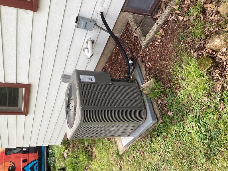 Completed annual Family Rewards cooling maintenance visit on residential air conditioning system. Performed comprehensive tune-up including disassembly of outdoor condenser unit, removal of accumulated leaves and debris from base, pressure washing of condenser coils, and full component inspection. Verified system operating properly with 22° temperature split across evaporator coil; unit is approximately one year old and performing within manufacturer specifications.