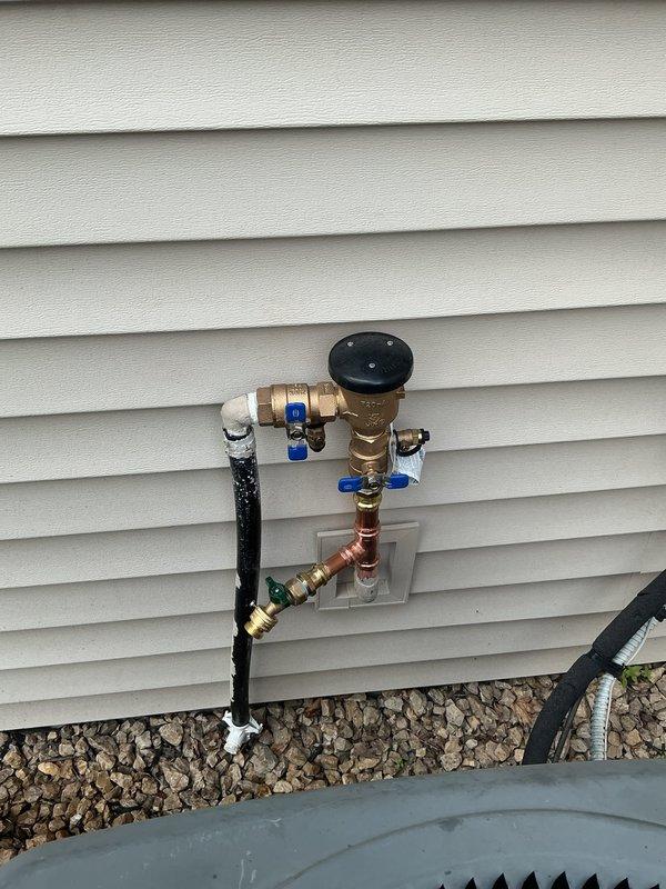Replaced frost-free hose bibb with new Woodford spigot utilizing existing connections up to 10 feet from water source. Installed irrigation atmospheric vacuum breaker for backflow prevention on exterior water supply system. Added two new ball valves to provide independent shut-off control points within the plumbing assembly, ensuring proper system isolation and maintenance capability.