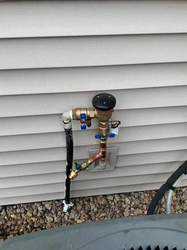 Replaced frost-free hose bibb with new Woodford spigot utilizing existing connections up to 10 feet from water source. Installed irrigation atmospheric vacuum breaker for backflow prevention on exterior water supply system. Added two new ball valves to provide independent shut-off control points within the plumbing assembly, ensuring proper system isolation and maintenance capability.