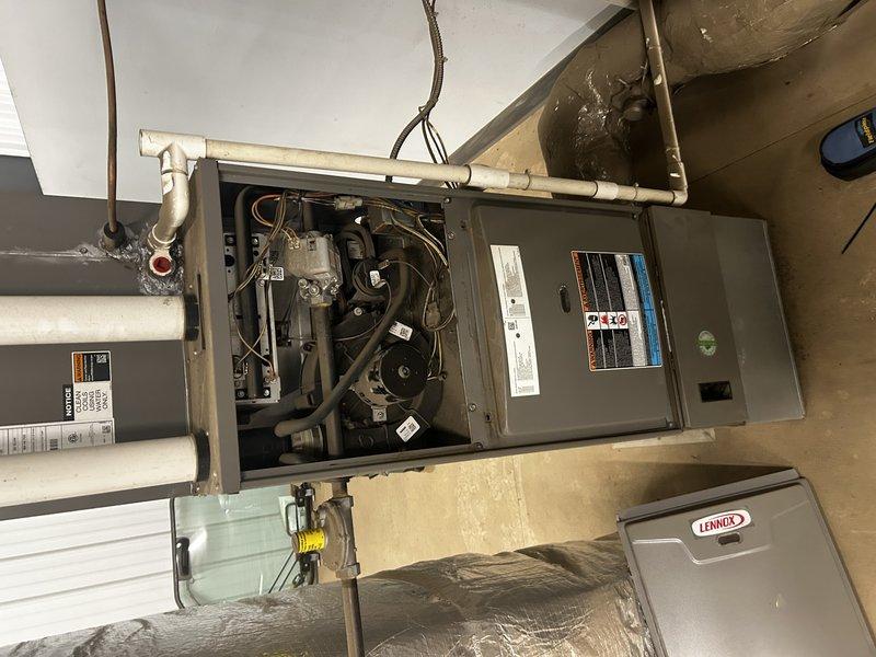 Responded to no heat call for commercial office with dual furnace system. Upon arrival, found two separate split systems: one ceiling-mounted unit serving office area controlled by hallway thermostat, and one upstairs unit serving break room controlled by break room thermostat.

Diagnosed break room thermostat displaying low battery warning, preventing upstairs furnace from initiating. Replaced thermostat batteries and verified successful furnace ignition and operation. Inspected air filter which showed moderate dust accumulation. Recommended filter replacement for both units.

Investigated ceiling-mounted furnace which was short-cycling and tripping on high limit safety. Found severely restricted air filter causing inadequate airflow and overheating condition. Accessed unit through drop ceiling using ladder due to challenging installation location with limited workspace. Identified extremely dirty filter as root cause of limit trips and inadequate heating. Advised customer to replace 