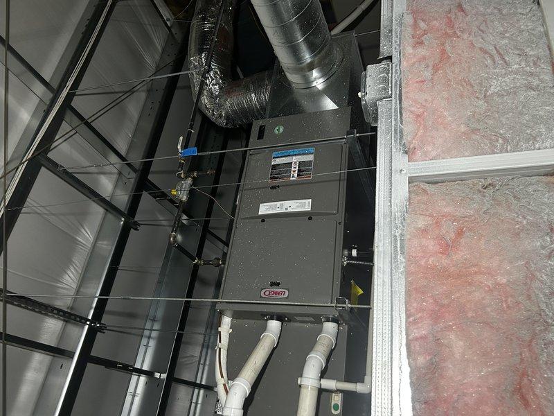 Responded to no heat call for commercial office with dual furnace system. Upon arrival, found two separate split systems: one ceiling-mounted unit serving office area controlled by hallway thermostat, and one upstairs unit serving break room controlled by break room thermostat.

Diagnosed break room thermostat displaying low battery warning, preventing upstairs furnace from initiating. Replaced thermostat batteries and verified successful furnace ignition and operation. Inspected air filter which showed moderate dust accumulation. Recommended filter replacement for both units.

Investigated ceiling-mounted furnace which was short-cycling and tripping on high limit safety. Found severely restricted air filter causing inadequate airflow and overheating condition. Accessed unit through drop ceiling using ladder due to challenging installation location with limited workspace. Identified extremely dirty filter as root cause of limit trips and inadequate heating. Advised customer to replace 