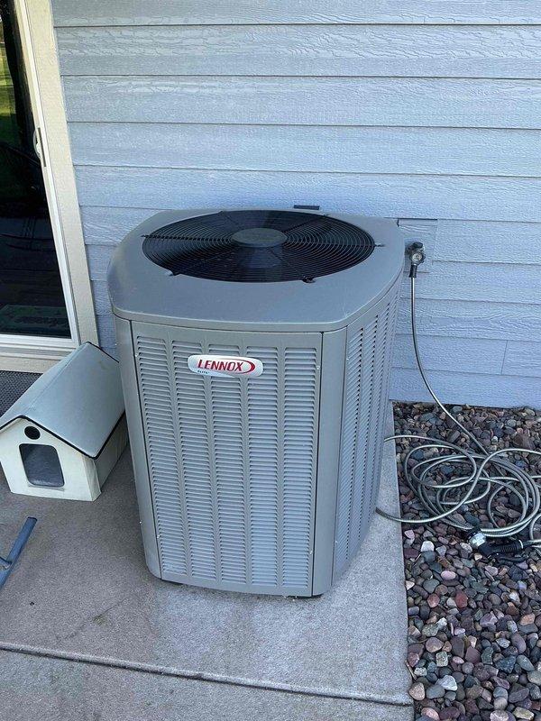Completed comprehensive air conditioning tune-up on Lennox outdoor condensing unit. Performed thorough cleaning of outdoor coil and cabinet, flushed condensate drain line at indoor air handler, and inspected air filter. System was operationally tested in maximum cooling mode and confirmed proper performance with all components functioning within normal parameters.