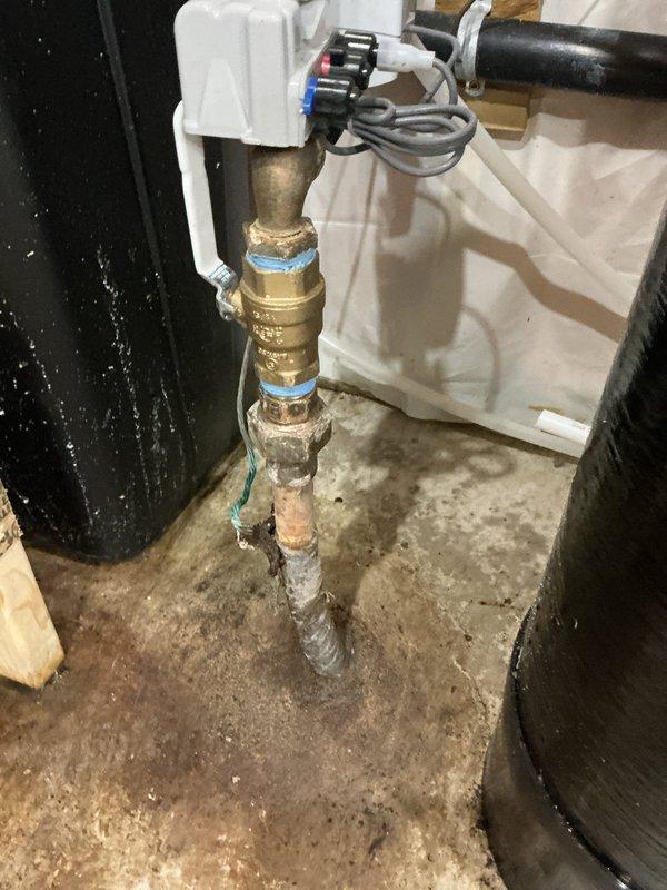 Completed comprehensive plumbing inspection and repairs addressing multiple findings from property inspection report. Installed new main shut-off valve to replace corroded existing valve on water main line entering the structure. Corrected improper water heater venting configuration to meet code requirements and ensure safe exhaust ventilation. Repaired leaking drain assembly under upstairs bathtub fixture. Addressed leak under bathroom sink drain. Assessed corroded copper water main piping showing significant oxidation and deterioration near floor penetration, documenting condition for future repair consideration. Evaluated sump pit water accumulation and confirmed absence of sump pump system. Documented utility sink requiring replacement due to cracked basin. All accessible repairs completed during single service visit, with photographic documentation provided for items requiring municipal coordination or future attention.