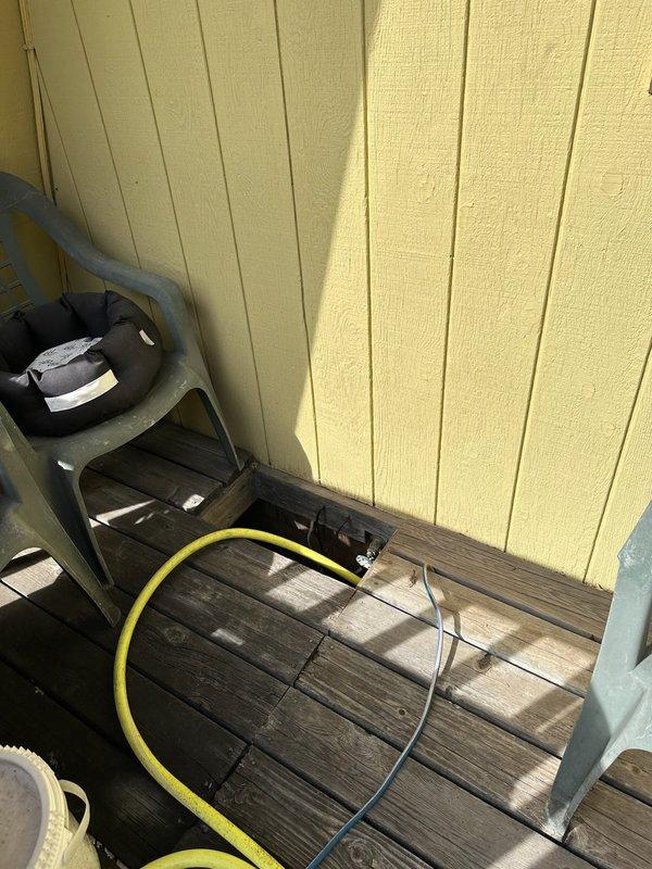 Responded to service call for leaking hose bibb located below deck floor level. Assessed existing spigot installation and provided estimate for replacement and relocation of hose bibb above deck surface to improve accessibility and prevent future water damage to deck structure. Inspection revealed compromised valve requiring complete replacement with new fixture and copper piping routed through deck framing.