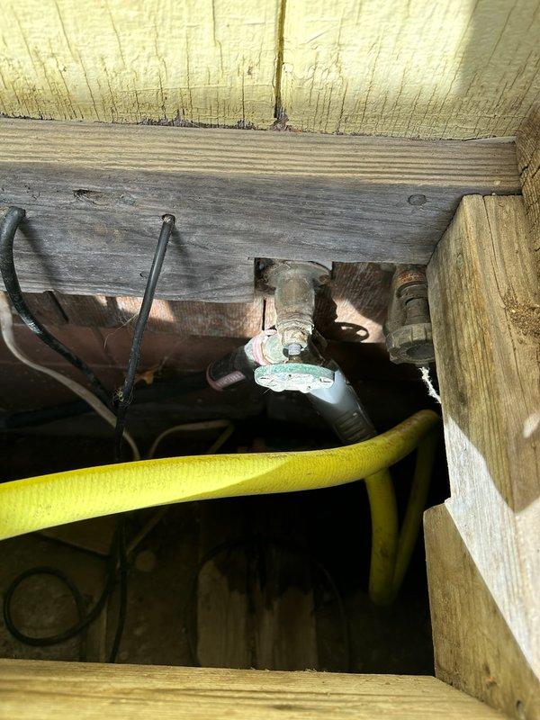 Responded to service call for leaking hose bibb located below deck floor level. Assessed existing spigot installation and provided estimate for replacement and relocation of hose bibb above deck surface to improve accessibility and prevent future water damage to deck structure. Inspection revealed compromised valve requiring complete replacement with new fixture and copper piping routed through deck framing.