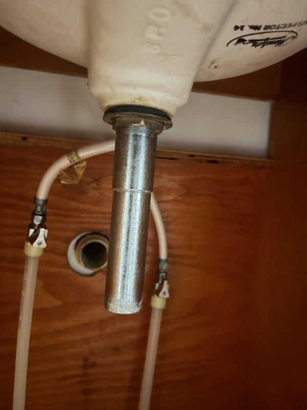 Replaced outdated bathroom and kitchen faucets with new builder-grade fixtures due to age and deterioration. Installed single-handle faucet in main level bathroom and kitchen faucet with side spray. Removed heavily corroded drain components and installed new sink drain assembly. All plumbing connections secured and tested for proper operation with no leaks detected.