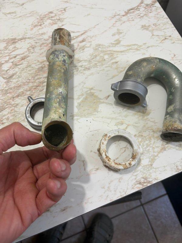 Replaced outdated bathroom and kitchen faucets with new builder-grade fixtures due to age and deterioration. Installed single-handle faucet in main level bathroom and kitchen faucet with side spray. Removed heavily corroded drain components and installed new sink drain assembly. All plumbing connections secured and tested for proper operation with no leaks detected.