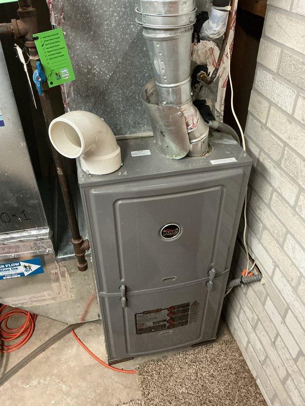 Completed comprehensive air conditioning tune-up and inspection on approximately 3-year-old system with Ruud furnace unit. System found to be operational with all components functioning within normal parameters, thermostat properly controlling temperature settings, and no deficiencies noted during inspection.