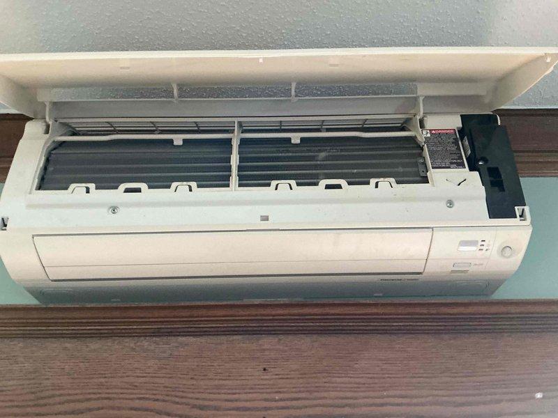 Completed annual cooling maintenance on a 3-year-old Daikin mini-split system consisting of one standard AC unit and one ductless mini-split. Cleaned air filters on both indoor units and verified temperature differential across evaporator coils met manufacturer specifications. Inspected living room wall-mounted head unit, finding minor dust accumulation on blower wheel with no mold present. Indoor evaporator coil showed good condition with no blockage or debris. Performed outdoor condenser coil cleaning, confirmed proper operation of condenser fan motor and compressor, and verified refrigerant charge within acceptable parameters. Ducted coil inspection was limited due to accessibility constraints in current installation. All accessible components operating within normal parameters.
