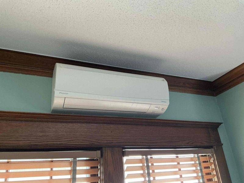 Completed annual cooling maintenance on a 3-year-old Daikin mini-split system consisting of one standard AC unit and one ductless mini-split. Cleaned air filters on both indoor units and verified temperature differential across evaporator coils met manufacturer specifications. Inspected living room wall-mounted head unit, finding minor dust accumulation on blower wheel with no mold present. Indoor evaporator coil showed good condition with no blockage or debris. Performed outdoor condenser coil cleaning, confirmed proper operation of condenser fan motor and compressor, and verified refrigerant charge within acceptable parameters. Ducted coil inspection was limited due to accessibility constraints in current installation. All accessible components operating within normal parameters.