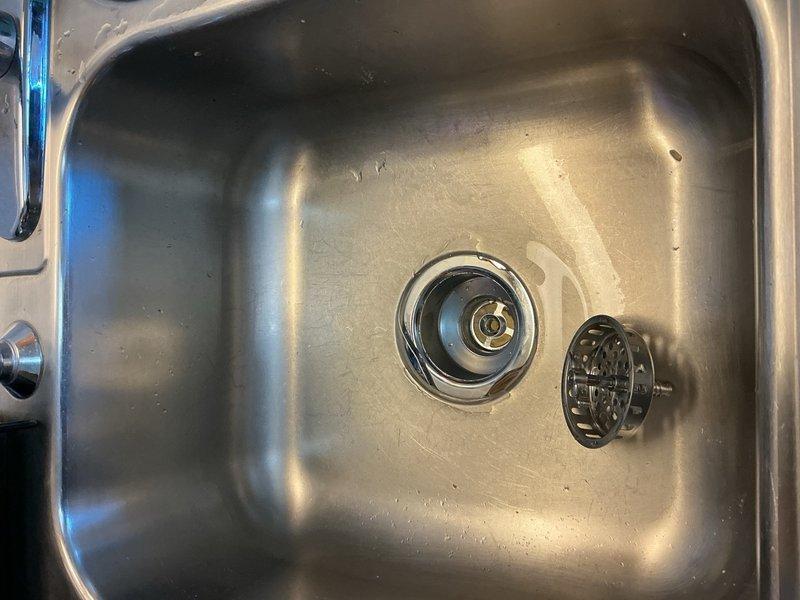 Completed annual plumbing inspection on duplex unit. All plumbing systems and fixtures were found to be in proper working condition. Identified worn left basket strainer on kitchen sink and replaced it with new unit upon approval. Documented conditions with photographs for service records.
