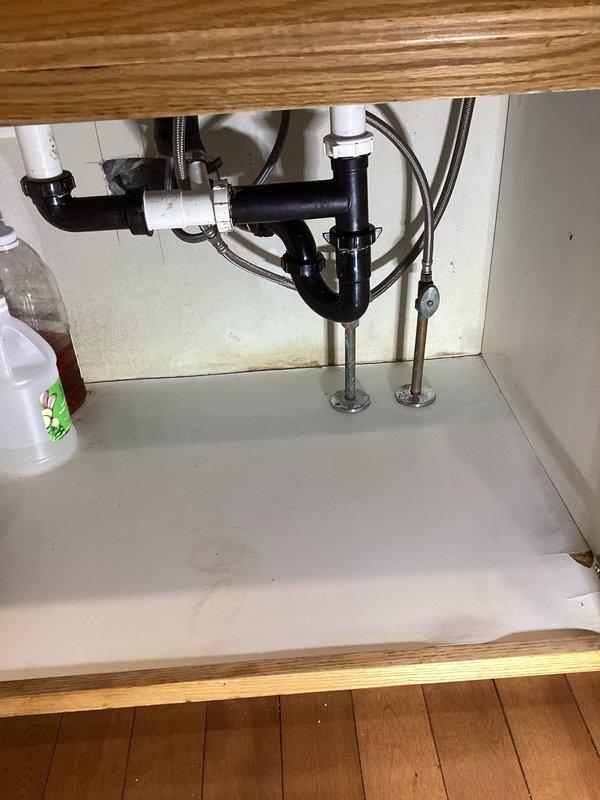 Responded to a slow-draining kitchen sink with significant buildup in the drain system. Upon inspection, discovered extensive sidewall buildup throughout the trap arm and right basket strainer, along with a leak at the basket strainer nut caused by a split nylon washer. Disassembled and thoroughly cleaned the trap arm assembly, removing all accumulated debris. Replaced the damaged nylon slip joint washer on the right basket strainer and reassembled the drain system. Tested for proper drainage and verified all connections were leak-free upon completion.