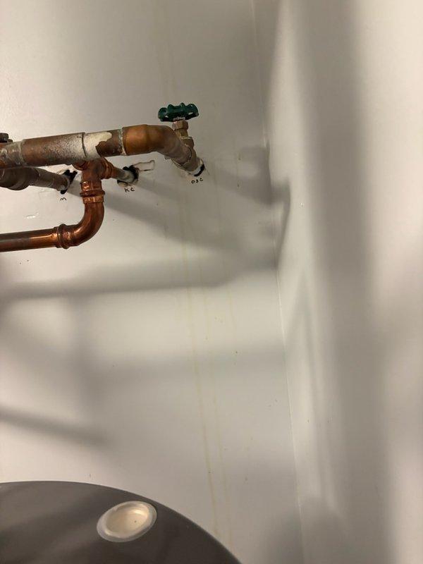 Responded to a water leak originating from the second-floor laundry room that was dripping through the ceiling below. Upon inspection, identified the source as a failing shut-off valve for the exterior hose bib. Removed the defective valve and installed a new ball valve to eliminate the leak and restore proper function to the outdoor water supply line.