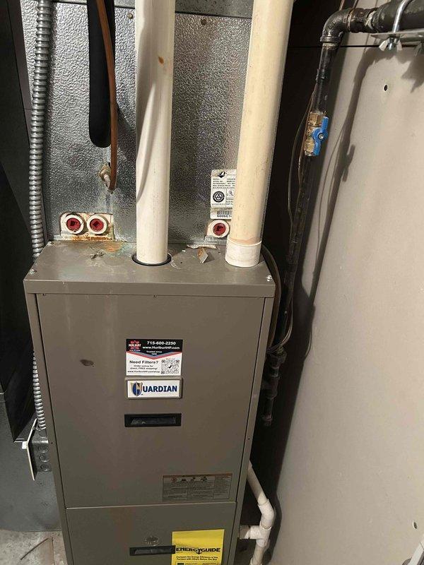 # HVAC Maintenance Agreement Completed

Performed comprehensive 12-point air conditioning tune-up on residential split system with Guardian furnace and outdoor condenser unit. Cleaned outdoor condenser equipment and coils, tested all electrical components for proper operation, and cleaned indoor evaporator drain line to ensure proper condensate removal. System evaluated and found to be cooling adequately, though operating near freezing threshold which will require monitoring. Captured detailed photographs of equipment including make, model, and serial number information for service records. Unit age uncertain; system appears to be functioning within acceptable parameters despite borderline temperature readings on evaporator coil.