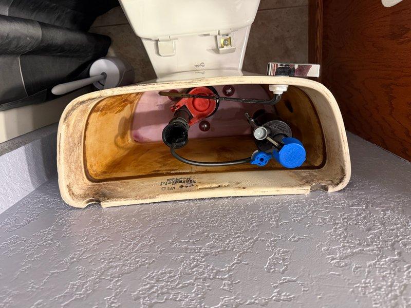 Responded to a continuously running toilet complaint. Upon inspection, identified a worn-out flapper causing intermittent running cycles where the tank would fill, stop briefly, then run again repeatedly. Replaced the defective flapper with a new unit, restoring proper tank seal and eliminating the continuous running issue.