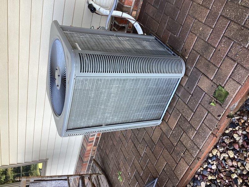 Completed scheduled Rewards maintenance tune-up on 3-year-old residential air conditioning system. Disassembled outdoor condenser unit and thoroughly cleaned heavily soiled condenser coil which exhibited significant accumulation of dirt, dust, and environmental debris with greenish-brown discoloration between fins. Washed coil and components, inspected all operational elements, and verified system performance with 22° temperature drop across evaporator coil, confirming proper refrigerant charge and efficient operation. Unit returned to full operational status with no issues identified.