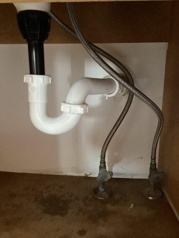 Disconnected kitchen sink faucet, dishwasher supply lines, and bathroom sink faucets to facilitate countertop replacement. Removed existing kitchen sink assembly and installed new bathroom faucets with supply line connections. All fixtures were properly disconnected from water supply valves and drain assemblies, with components staged for reinstallation upon completion of countertop work.
