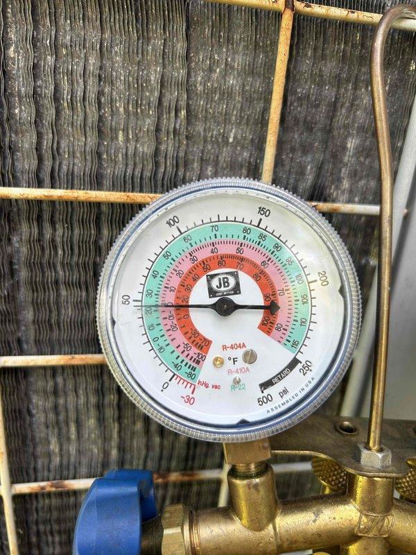 Performed comprehensive AC tune-up on 30-year-old Tempstar R-22 system. Inspected outdoor unit components, rinsed condenser coil, verified blower wheel and evaporator coil cleanliness, and confirmed clean filter. During operational testing, discovered suction line freezing with low pressure reading of approximately 45 PSI, indicating significant refrigerant undercharge from previous service by another company. Scheduled service advisor for follow-up refrigerant evaluation and system diagnostics to address the R-22 charging issue.