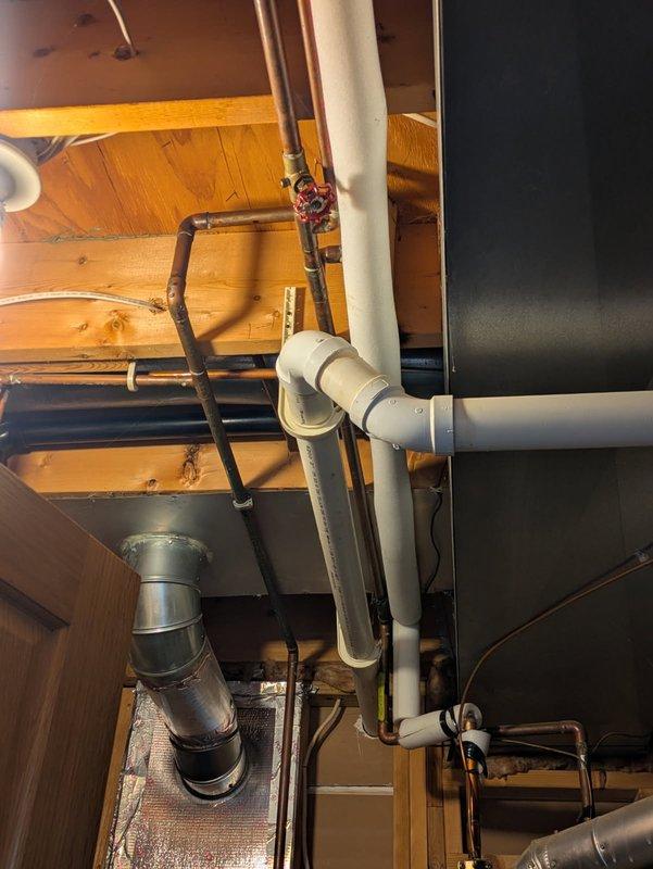 Responded to water leak in boiler room where a shut-off valve on overhead piping near the water heater was actively leaking. Replaced the defective valve and restored proper function to the plumbing system. Documented the mechanical room configuration and repaired plumbing infrastructure with photos for service records.