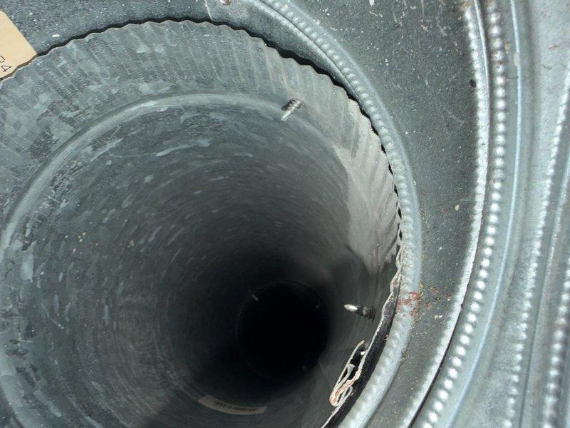 Performed comprehensive duct cleaning service on residential HVAC system including mobilization and setup. Inspected ductwork in response to reported dead animal odor near utility room and investigated potential animal entry points in ceiling and duct connections. Found no evidence of animal presence in accessible ductwork or disconnected components. Cleaned 15 openings including all supply and return ducts which contained accumulated dust, dirt, and debris. Utilized professional duct cleaning equipment to thoroughly remove contaminants from interior duct surfaces. Verified proper cleaning of all ductwork components and confirmed system cleanliness upon completion. Documented pre-cleaning conditions showing significant dust accumulation on galvanized metal ductwork and flexible ducting components, as well as attic space framing and insulation areas near duct system.