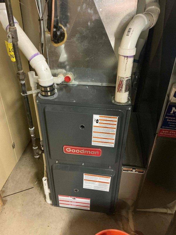 Completed annual cooling maintenance visit on 25-year-old Goodman AC system. During tune-up inspection, identified system operating with low refrigerant charge of obsolete refrigerant type. Documented equipment condition with photos showing furnace and associated utility connections. Provided repair options to customer via email and scheduled estimate appointment for new AC or heat pump replacement system due to age of existing equipment and refrigerant obsolescence.