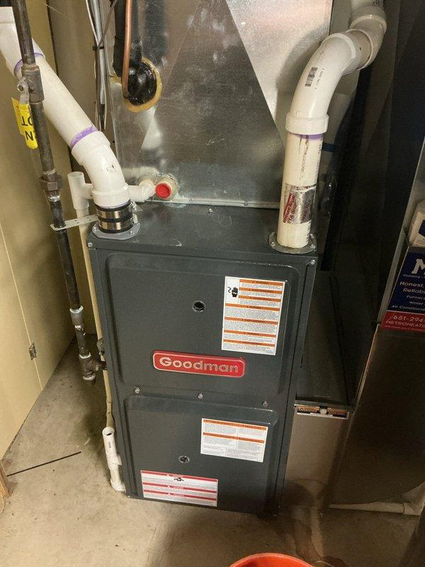 Completed annual cooling maintenance visit on 25-year-old Goodman AC system. During tune-up inspection, identified system operating with low refrigerant charge of obsolete refrigerant type. Documented equipment condition with photos showing furnace and associated utility connections. Provided repair options to customer via email and scheduled estimate appointment for new AC or heat pump replacement system due to age of existing equipment and refrigerant obsolescence.