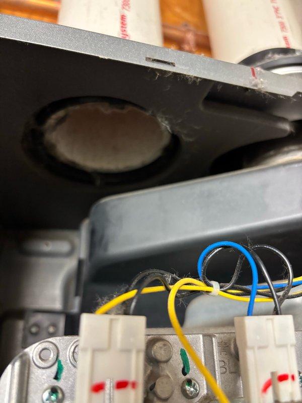 Responded to service call for low hot water issues in women's locker room affecting dual tankless water heater system. Upon arrival, found both units short cycling with Error Code 10 indicating air flow restriction. Performed diagnostic inspection of intake vents on both heaters and confirmed no visible blockages present. Exhausts were inaccessible due to sealed installation and lack of roof access for verification. Consulted with manufacturer technical support who advised that internal dust and debris accumulation on fan assembly, heat exchanger, or burner components was likely causing air restriction and system errors. Technical support recommended either replacing affected components (fan, heat exchanger, and/or burner) or full unit replacement to resolve the issue. Also investigated possibility of bad check valves or mixing valve cartridges in utility sink or shower fixtures that could be causing cold water crossover into hot water lines, which would contribute to perceived water h