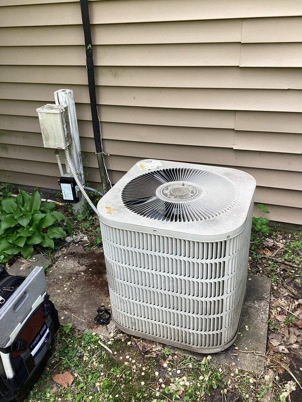 Responded to no cooling complaint on aging outdoor condensing unit. Upon arrival, confirmed system was not producing cold air. Performed diagnostic testing and found compressor failing to start despite proper voltage supply. Tested run capacitor and found it within acceptable range, ruling out capacitor failure as root cause. Determined compressor had failed mechanically and was unable to start under load. Due to age of unit and extent of corrosion visible on electrical components and cabinet, recommended full system replacement rather than compressor replacement. Explained to customer that compressor replacement on a system over 10 years old is typically not cost-effective due to reduced efficiency of other aging components and likelihood of additional failures. Customer approved compressor replacement as temporary solution. Removed failed compressor, installed replacement compressor, and reconnected all electrical connections. Evacuated system, pressure tested for leaks, and recharge
