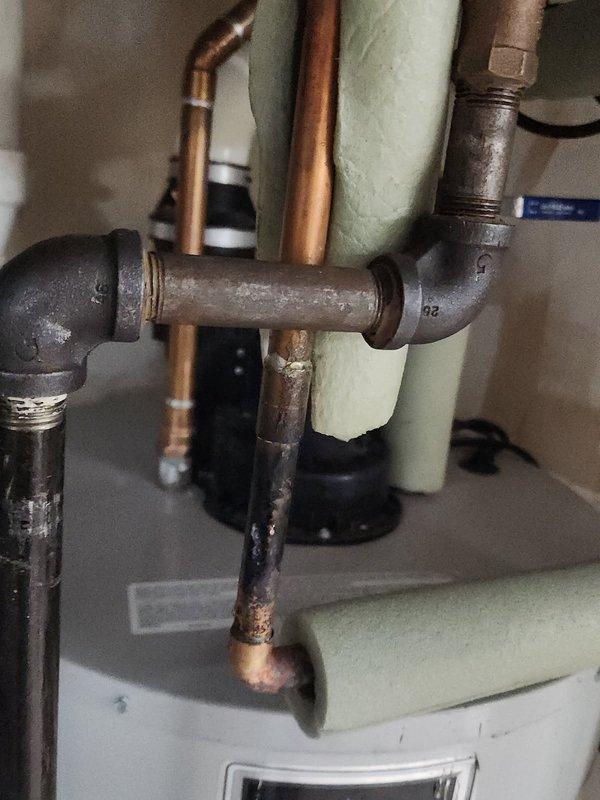 Responded to water leak emergency at residential water heater. Upon arrival, confirmed main water supply had been shut off by homeowner. Inspected copper piping connected to hot water heater and identified pinhole leak in recirculation line at a different location from previous repair. Determined that copper pipe deterioration warranted full replacement rather than additional patch repair.

Removed approximately 6 feet of corroded copper piping from the hot water heater recirculation system, including previously repaired section. Installed new PEX piping to replace deteriorated copper line, ensuring proper connections at water heater inlet/outlet and throughout recirculation loop. Utilized appropriate transition fittings to connect PEX to existing copper and threaded connections at water heater. Pressure tested all new connections to verify system integrity and absence of leaks.

Restored water supply and verified proper operation of water heater and recirculation system. Documented in