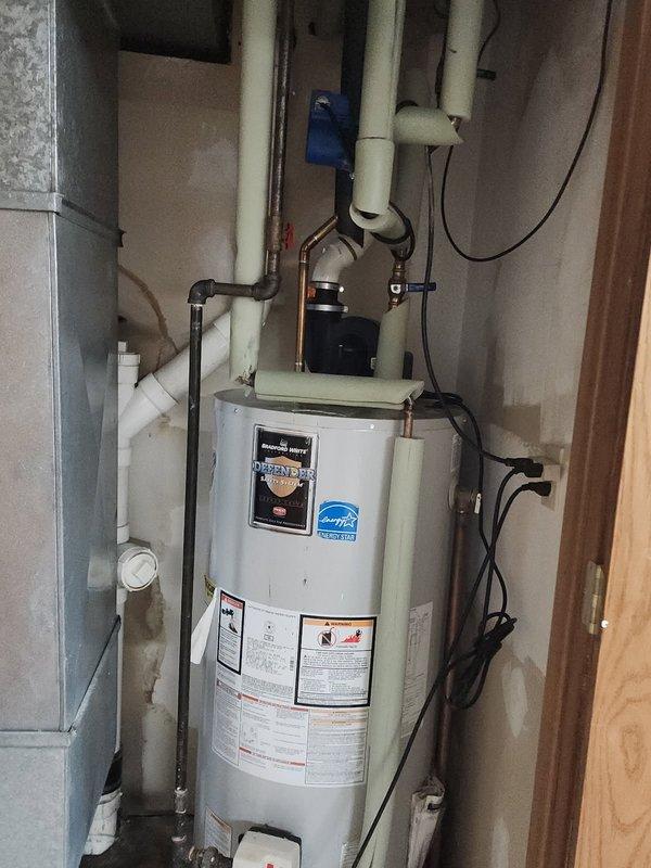 Responded to water leak emergency at residential water heater. Upon arrival, confirmed main water supply had been shut off by homeowner. Inspected copper piping connected to hot water heater and identified pinhole leak in recirculation line at a different location from previous repair. Determined that copper pipe deterioration warranted full replacement rather than additional patch repair.

Removed approximately 6 feet of corroded copper piping from the hot water heater recirculation system, including previously repaired section. Installed new PEX piping to replace deteriorated copper line, ensuring proper connections at water heater inlet/outlet and throughout recirculation loop. Utilized appropriate transition fittings to connect PEX to existing copper and threaded connections at water heater. Pressure tested all new connections to verify system integrity and absence of leaks.

Restored water supply and verified proper operation of water heater and recirculation system. Documented in