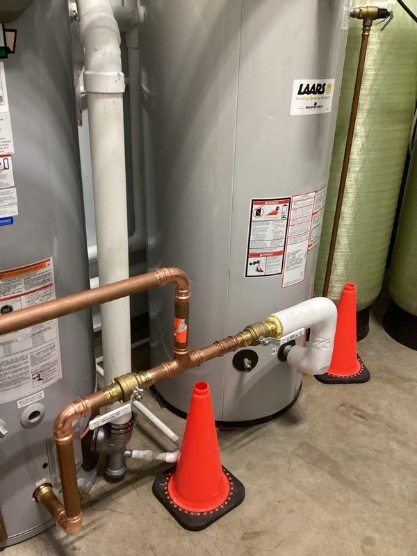 Responded to commercial facility for failed water heater with active leak. Removed existing defective unit and installed new 100-gallon commercial-grade tanked water heater. Completed all copper piping connections with proper soldering techniques, installed brass ball valves for system isolation, and integrated PVC venting per manufacturer specifications. Connected hot and cold water supply lines, installed expansion tank, and verified all connections for leaks. Mounted temperature and pressure relief valve with appropriate discharge piping. System tested, pressurized, and confirmed operational with no leaks detected.