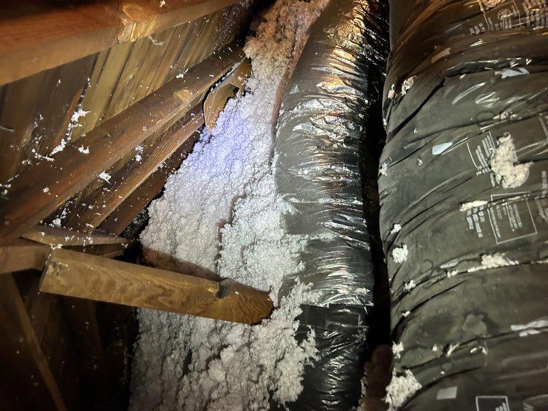 Completed preventative maintenance tune-up on 15-20 year old air conditioning system located in attic space accessible through interior closet. During inspection, identified defective capacitor with low readings and replaced with new unit to restore proper system operation. Observed significant condensation accumulation and frost buildup on exposed ductwork and insulation, indicating potential insulation deficiency or airflow issues requiring further assessment. Coordinated follow-up sales consultation to provide estimate for ductwork remediation and insulation improvements.