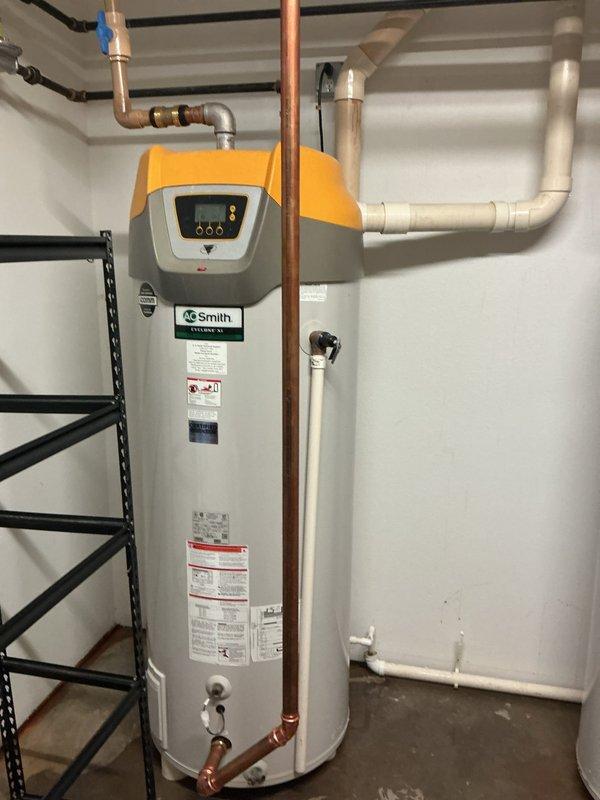 Responded to water leak reported between dual water heater installation and adjacent laundry room. Upon investigation, identified compromised hot water supply line within wall cavity that had also caused catastrophic failure of one water heater tank. Executed repairs to damaged hot water piping and isolated the ruptured water heater unit to prevent further water damage and restore system functionality to the remaining operational heater.