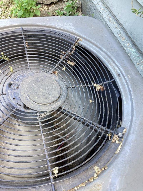 Performed AC tuneup and system inspection on residential condensing unit. Upon arrival, discovered significant damage to condenser unit with compromised fan guard and visible refrigerant leak requiring immediate attention. Documented equipment condition with photographs showing weathered outdoor unit with debris accumulation and inspected indoor air filtration system. Discussed repair options and replacement recommendations with homeowner due to extent of damage, with follow-up appointment scheduled for equipment replacement consultation.