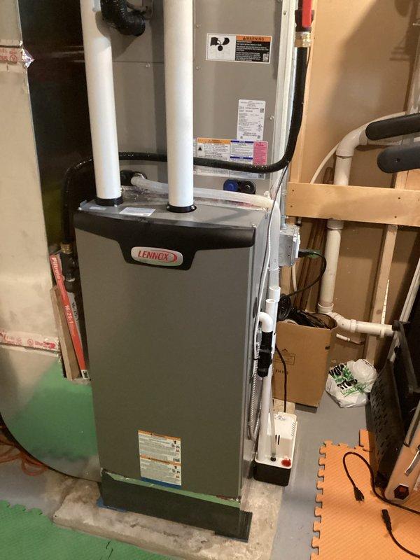 Responded to report of water accumulation around furnace unit installed last year with concerns about improper air filtration. Upon inspection, discovered blower fan speeds were set to medium-low, causing inadequate airflow across the evaporator coil which resulted in coil freezing and subsequent water discharge. Adjusted blower fan speeds to proper settings and verified coil temperature had risen above 32°F to confirm thawing. Measured and documented system pressures and temperatures using refrigerant manifold gauges. Indoor ambient temperature recorded at 68°F with outdoor temperature at 67°F. System operational with corrected airflow upon departure.
