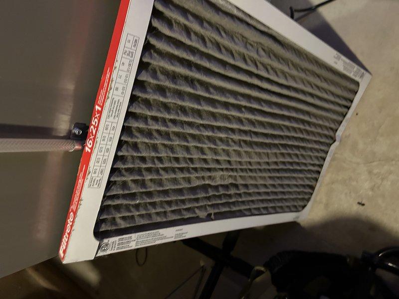 Responded to no cooling call on Lennox ML14XC1S522 central air conditioning unit experiencing frozen evaporator coil with ice formation on outdoor unit. Found severely restricted airflow caused by heavily soiled air filter. Replaced dirty filter with new unit, allowed system to thaw, and performed diagnostic testing with manifold gauges to verify proper refrigerant pressures and system operation. System restored to normal cooling function with proper airflow and temperature differential.