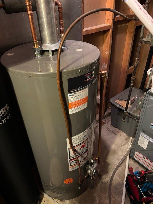 Drained residential water heater and successfully replaced the failed dielectric union on the cold water inlet side. Cut out the existing deteriorated union, installed new dielectric union with proper copper connections, restored water supply, and performed leak testing to verify system integrity. Water heater returned to full service with all connections secure and operating properly.
