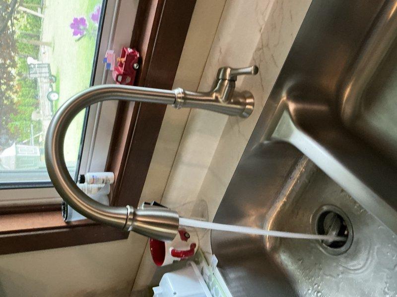 Responded to kitchen sink leak caused by improper supply line adapter installation. Removed faulty connections and installed two new compression straight stops to provide proper shut-off capability where none previously existed. Tested all connections and verified system is leak-free and functioning properly.